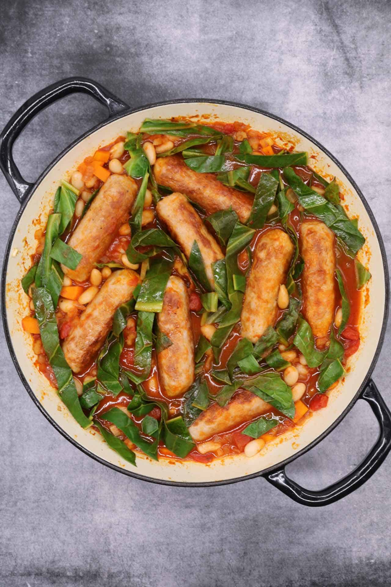 Sausage and cannellini bean casserole in large round casserole