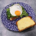 BLT Cheese and with fried egg on blue and white plate