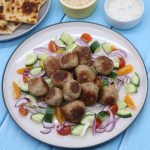 Meze meatballs with cucumber and tomato salad with flat breads and sauce
