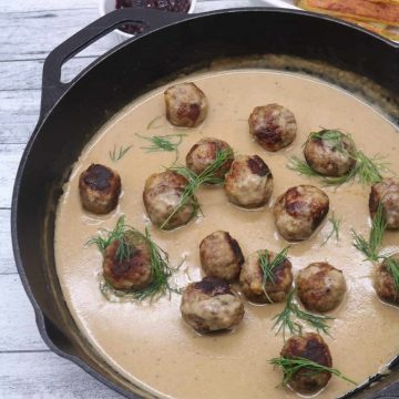 Scandi meatballs in gravy scattered with dill in skillet