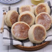 English muffins on black and white towel in bread basket