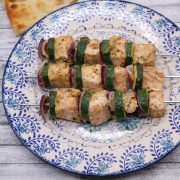 Mediterranean salmon kebabs on a blue and white plate