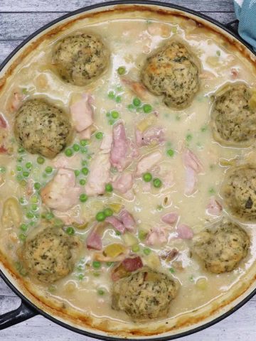 Chicken and gammon stew with dumplings in large round casserole