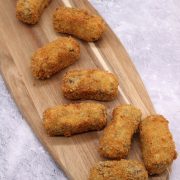 Haggis neeps and tatties croquettes on a wooden board