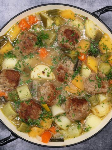 Lamb meatball cawl in large round casserole