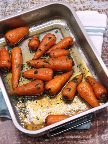 Sweet roasted chantenay carrots in small rectangle roasting tin