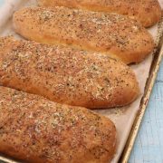 Italian herby sub rolls on baking tray