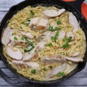 Chicken alfredo with pasta in skillet
