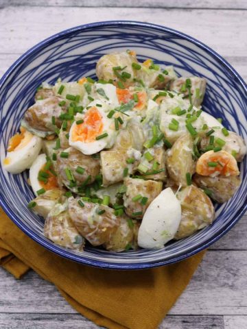 Jersey royal potato salad in blue and white bowl