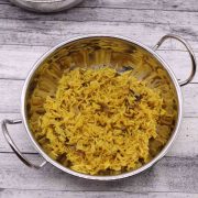 Golden pilau rice in balti dish with chicken jalfrezi in balti dish