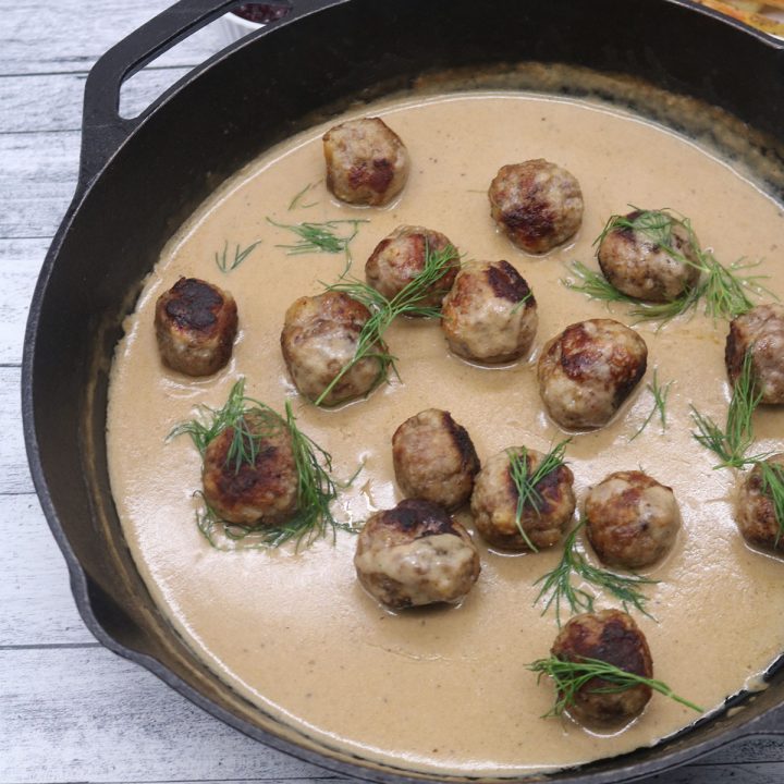 Scandi meatballs in skillet with gravy and dill