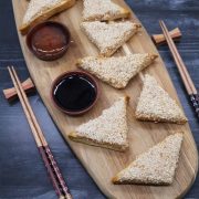 Easy air fryer prawn toast on wooden board with chopsticks and dipping sauces