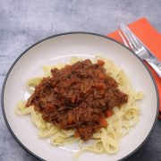 Slow cooker beef ragu in bowl with pasta