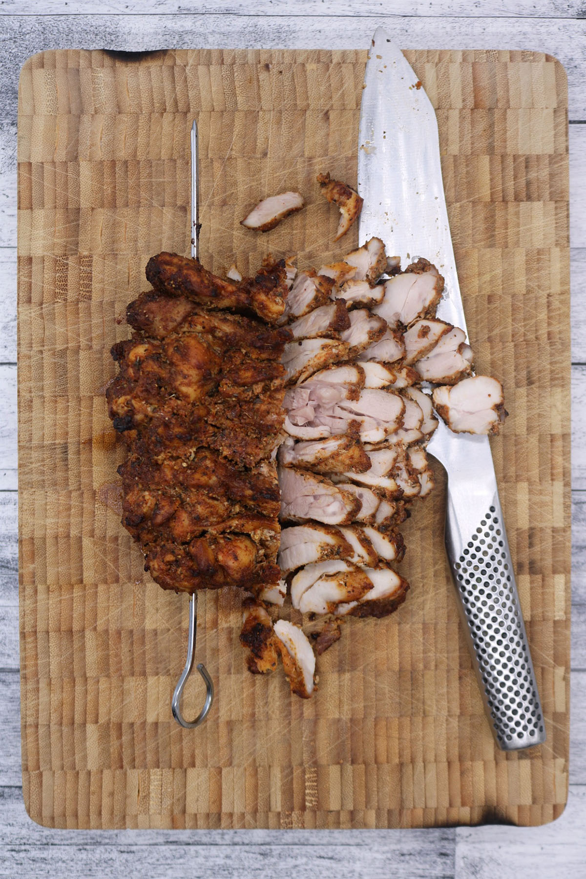 Chicken gyros meat on wooden board with knife