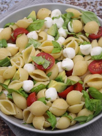 Caprese pasta salad in grey bowl