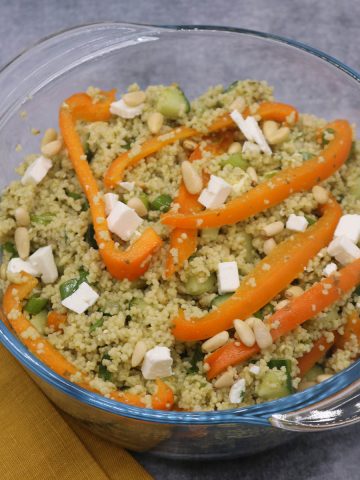 Couscous salad with feta in clear bowl