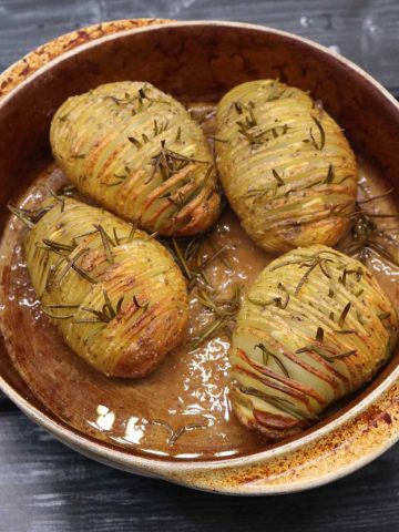 garlic and rosemary hasselback potatoes in round oven dish