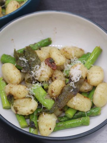 Gnocchi with asparagus, sage and lemon butter in bowls
