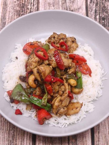 Kung pao chicken in grey bowl with rice