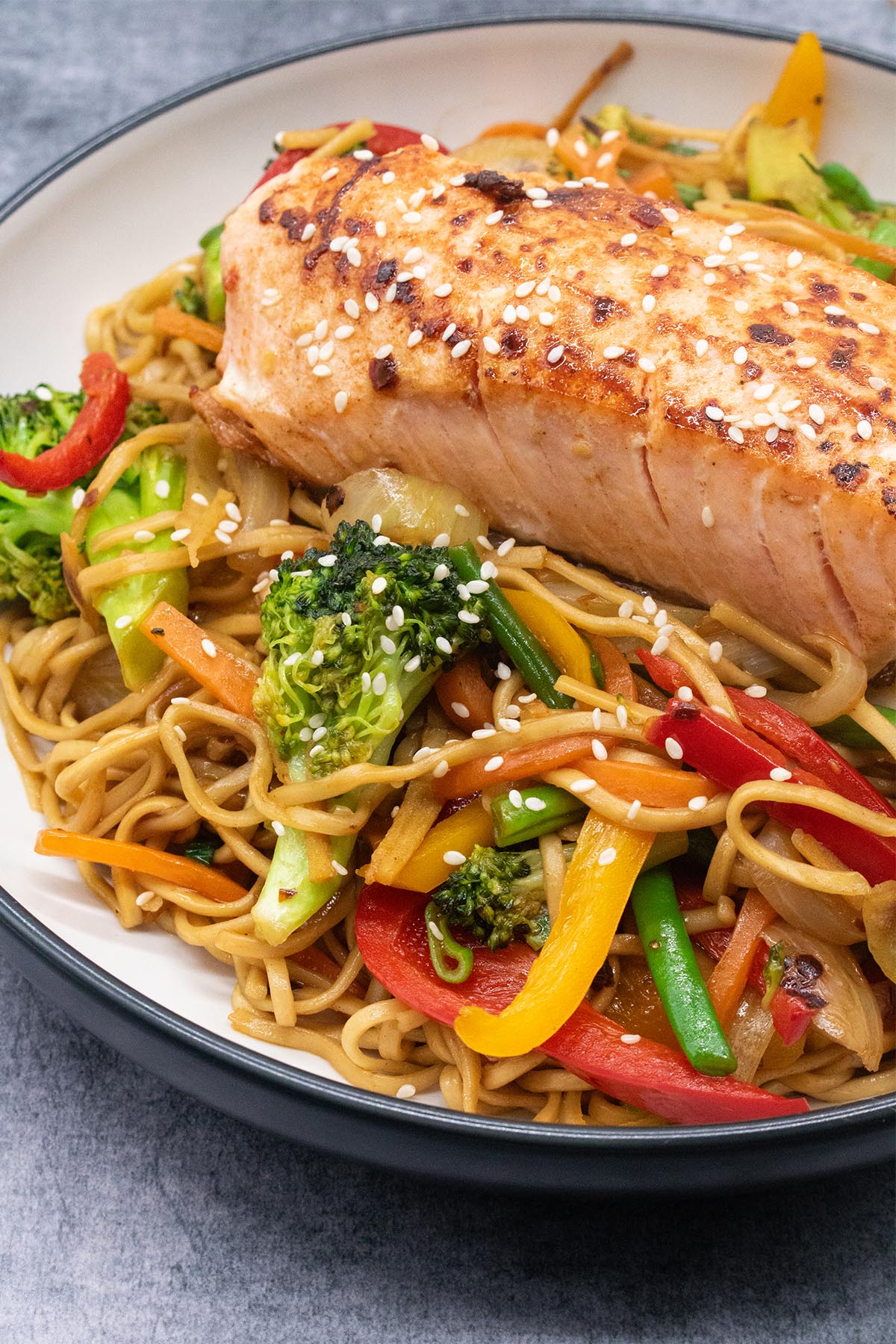 Close up of Salmon in a bowl with noodles and vegetables