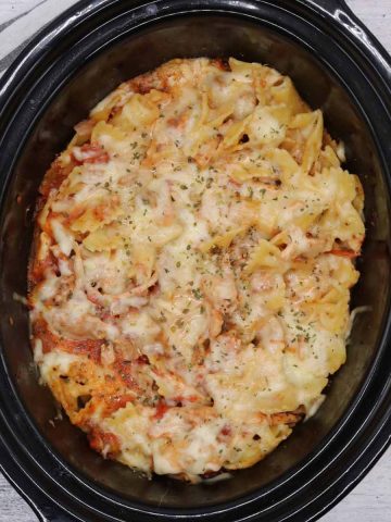 slow cooker with chicken parmesan pasta bake inside