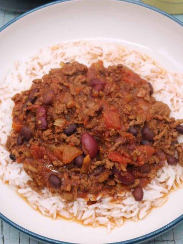 Slow cooker chilli in bowl on bed of rice