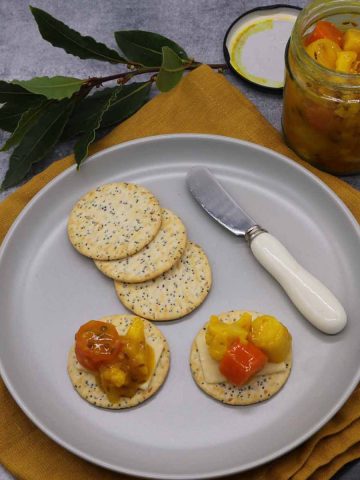 Plate with crackers spread with winter veg piccalilli and jar in background