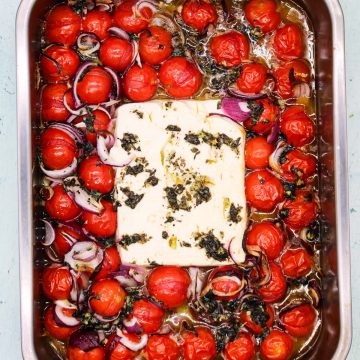 Baked feta with tomatoes in rectangle oven tray