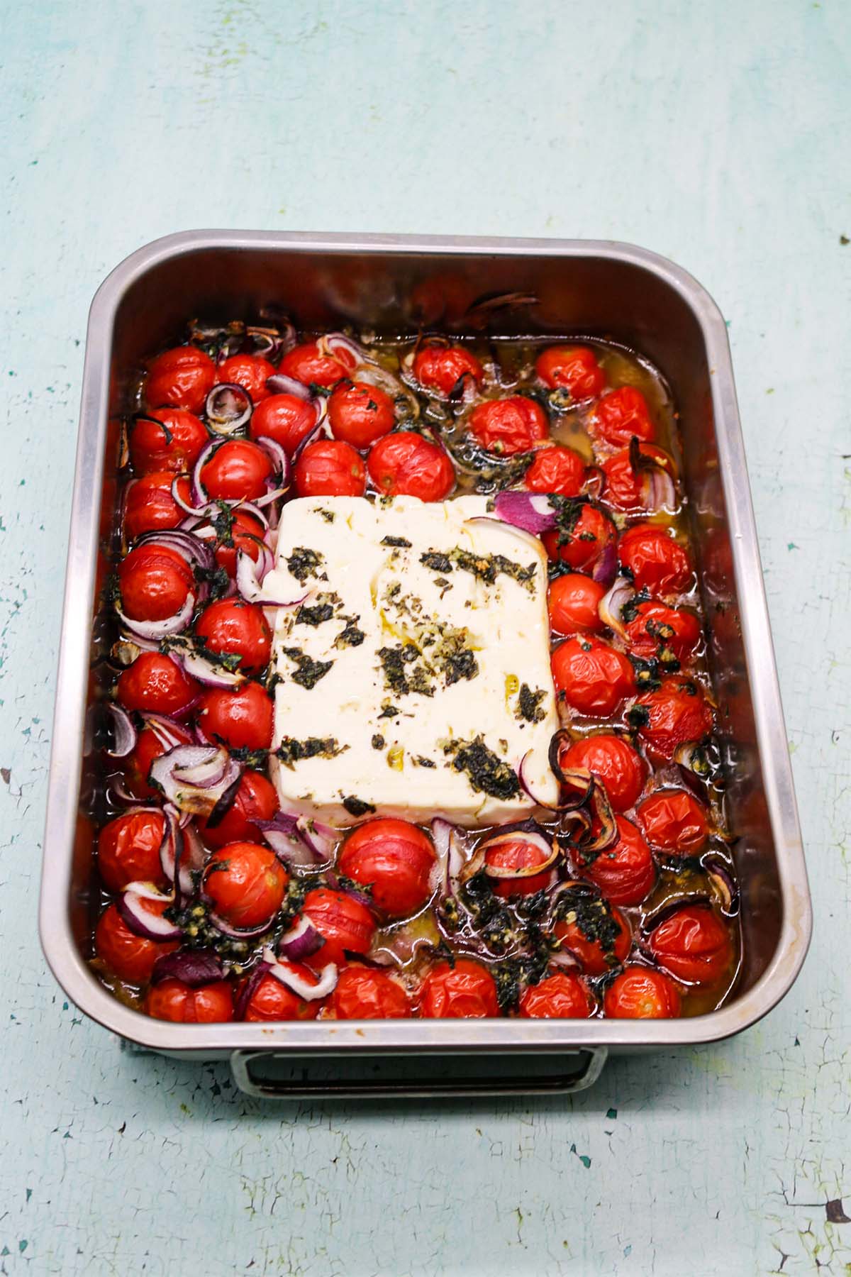 Baked feta with tomatoes in rectangle oven tray