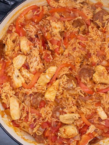 close up of chicken and chorizo jambalaya in a round casserole dish