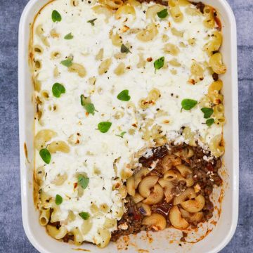 Easy greek pasticcio in rectangle oven dish with portion taken out