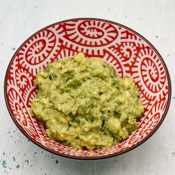 Guacamole in red and white serving bowl