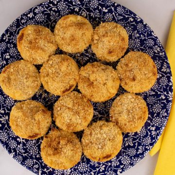 Mac and cheese muffins on blue dinner plate with white berry pattern