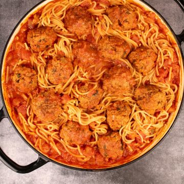 Overhead of 'nduja meatballs with spaghetti in large round casserole