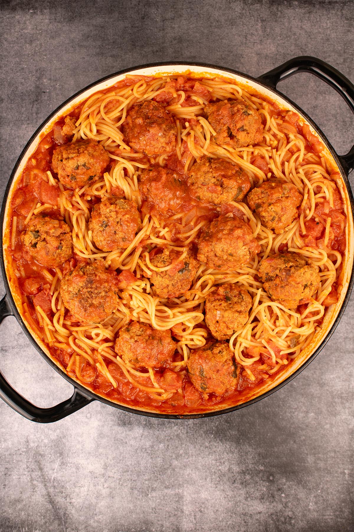 Overhead of 'nduja meatballs with spaghetti in large round casserole