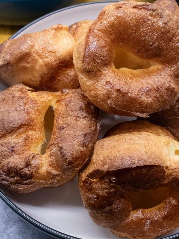 close up of Yorkshire puddings in a white bowl