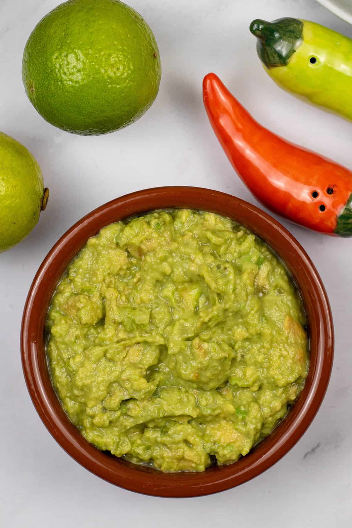 Guacamole in a terracotta serving dish.