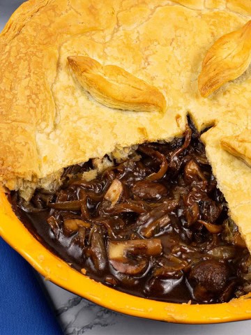 Mushroom and Guinness pie in a round yellow pie dish.