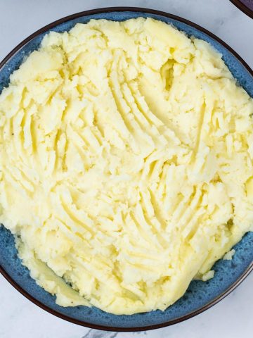 Mashed potatoes in a blue patterned serving bowl.